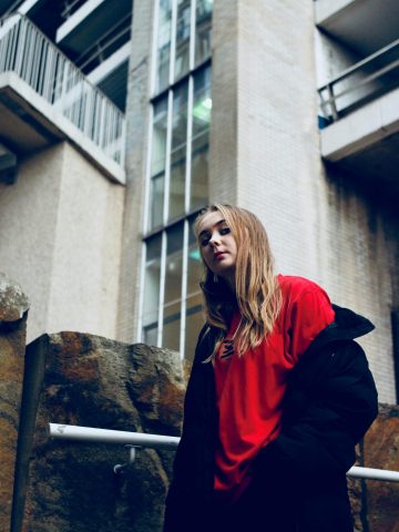 Stylish portrait of a confident young woman in Bristol's urban setting.